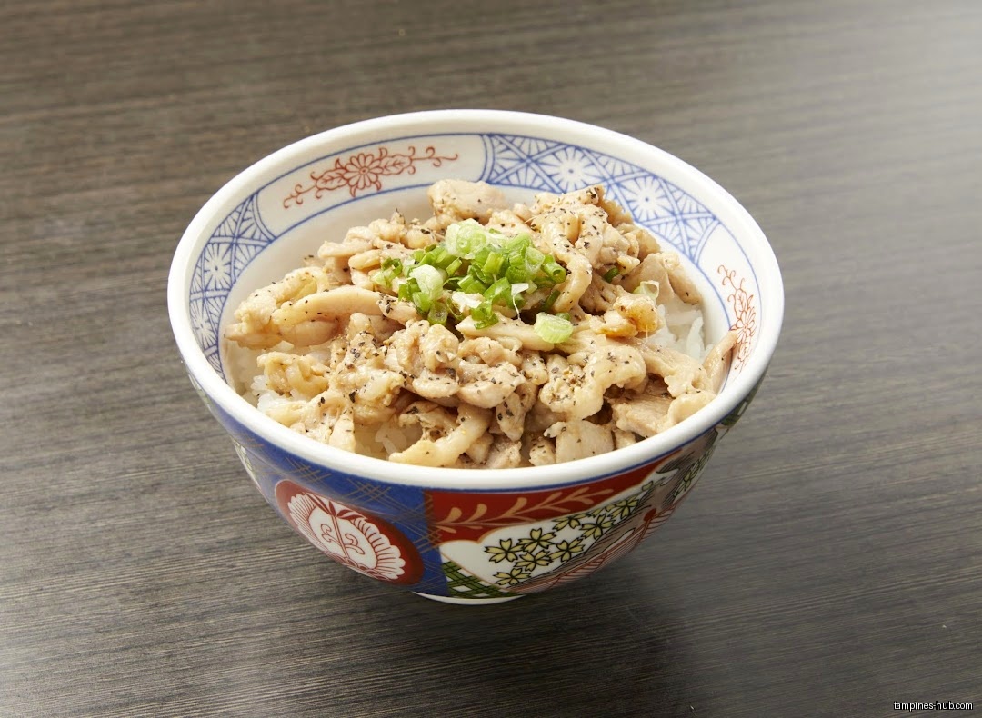 A bowl of rice topped with meat and green onions is shown.