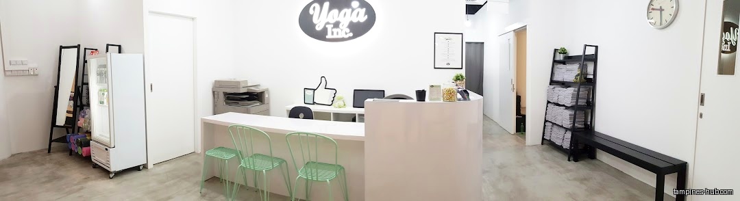 The image shows the interior of Yoga Inc Tampines with a reception desk.