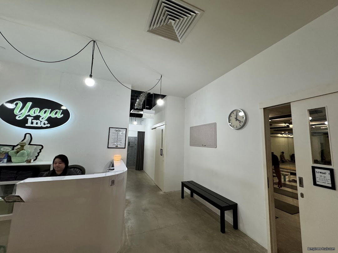 Yoga Inc Tampines reception area with a staff member at the desk.