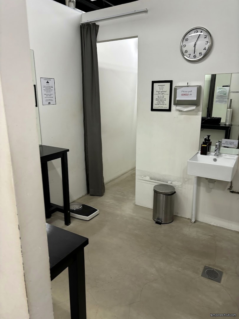 The image shows a changing room with a sink and a scale.