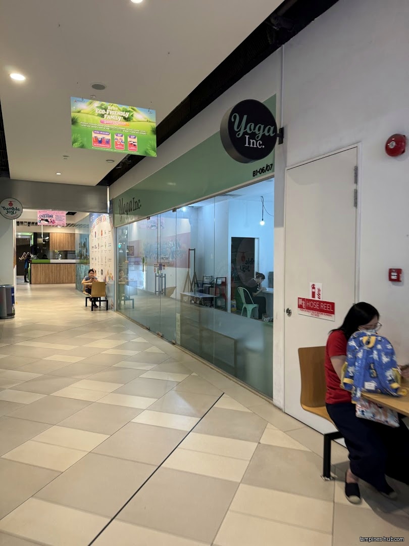 The image shows the exterior of Yoga Inc Tampines in a mall.