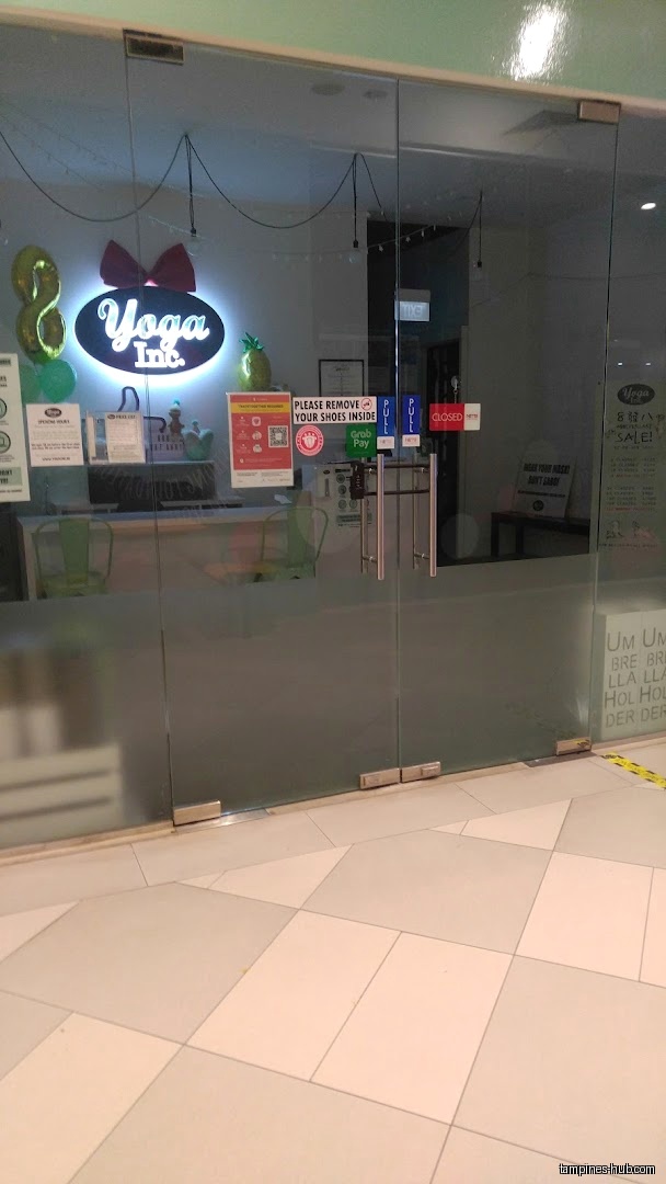 The shop front of Yoga Inc Tampines with glass doors and signage.