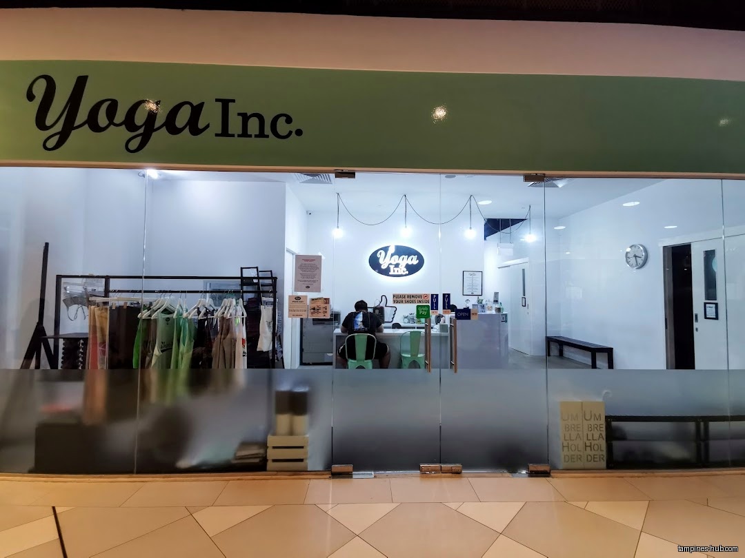 Yoga Inc Tampines shop front with glass doors and clothing rack.