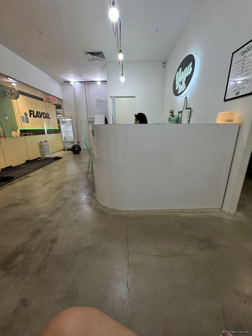 Interior view of Yoga Inc Tampines with a white reception desk.