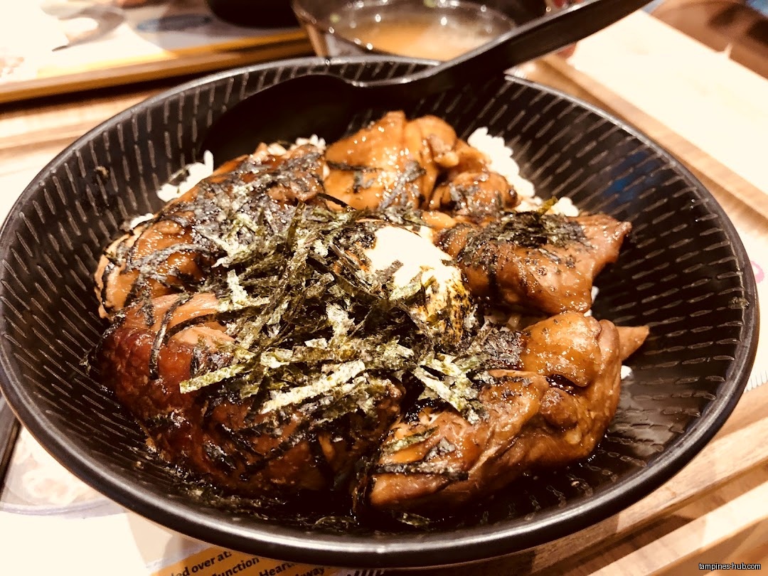 A bowl of teriyaki chicken with rice and seaweed is shown.