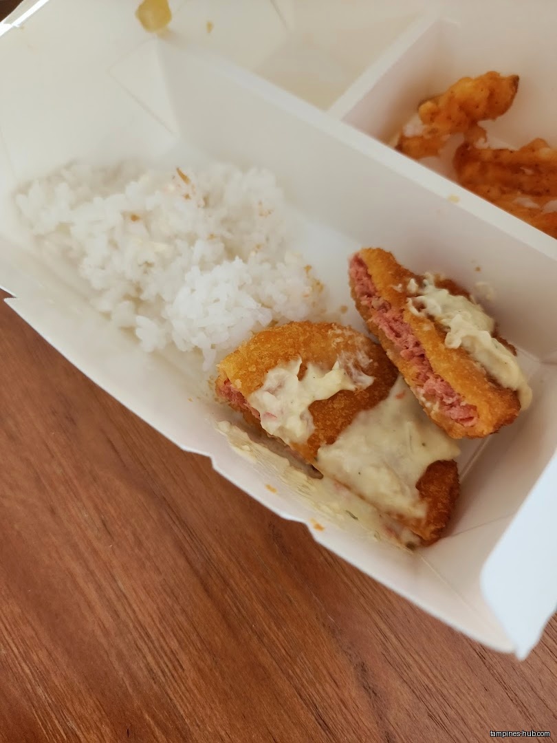 A Yoshinoya meal box with rice, fried food, and sauce.